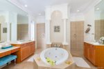 The master bathroom features dual sinks, jetted tub and separate toilet